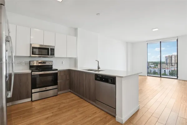 a kitchen with granite countertop a stove and a microwave