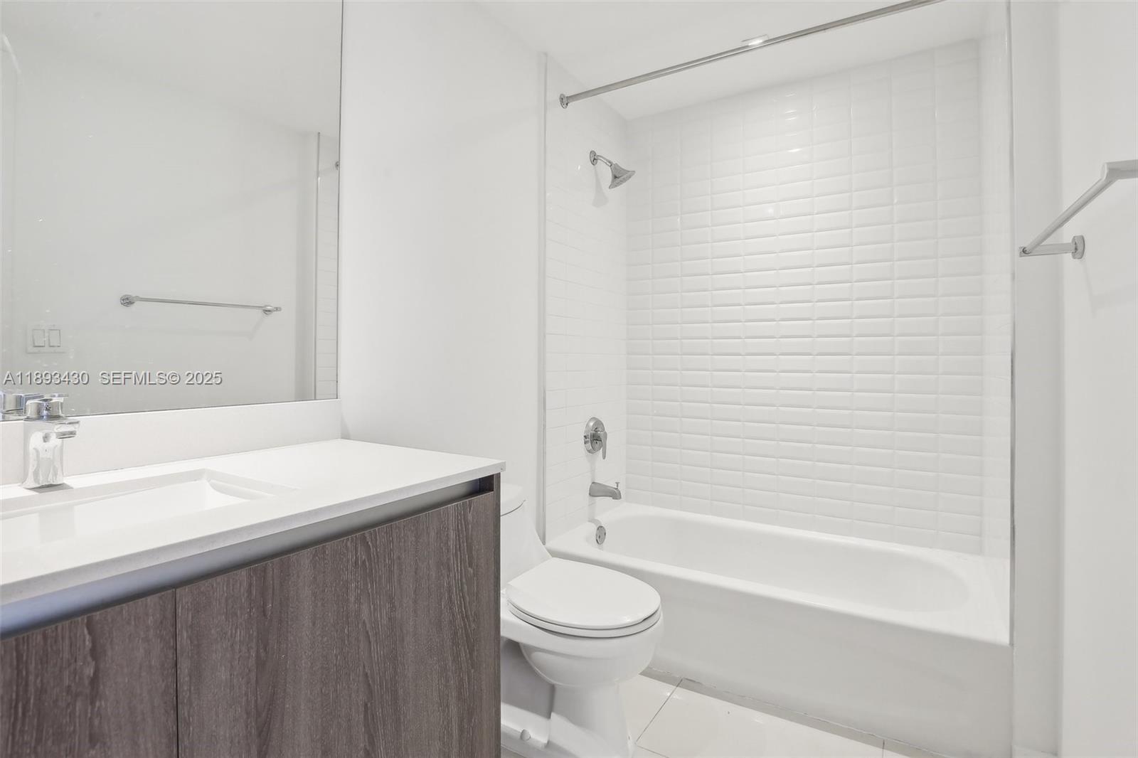 1501 Southwest 37th Avenue, Unit 708 Miami, FL 33145 - Photo 15 of 27 a bathroom with a sink a toilet and a bathtub