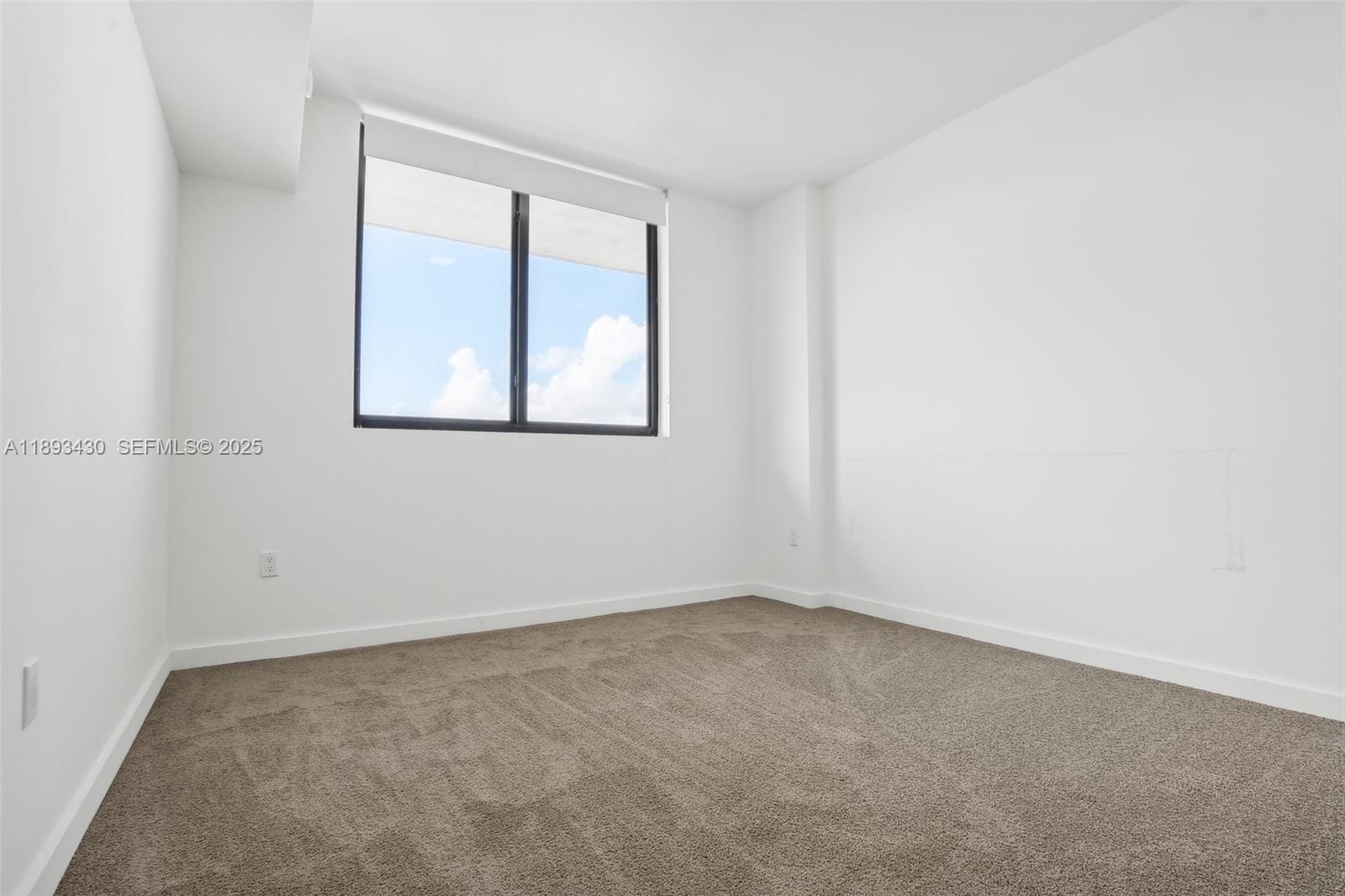 1501 Southwest 37th Avenue, Unit 708 Miami, FL 33145 - Photo 16 of 27 an empty room with a window