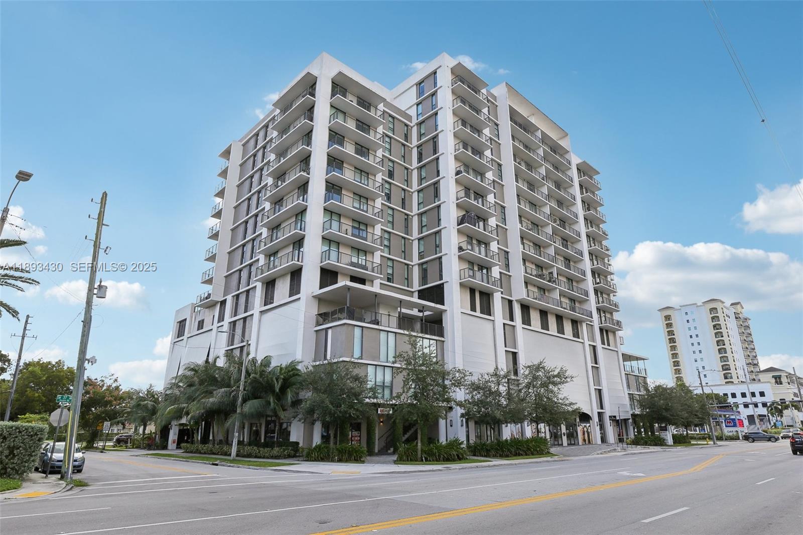 1501 Southwest 37th Avenue, Unit 708 Miami, FL 33145 - Photo 2 of 27 a view of a tall building next to a road