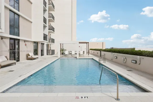 a view of a swimming pool with a lounge chair