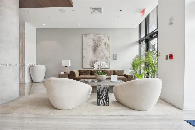 a view of living room filled with furniture and window