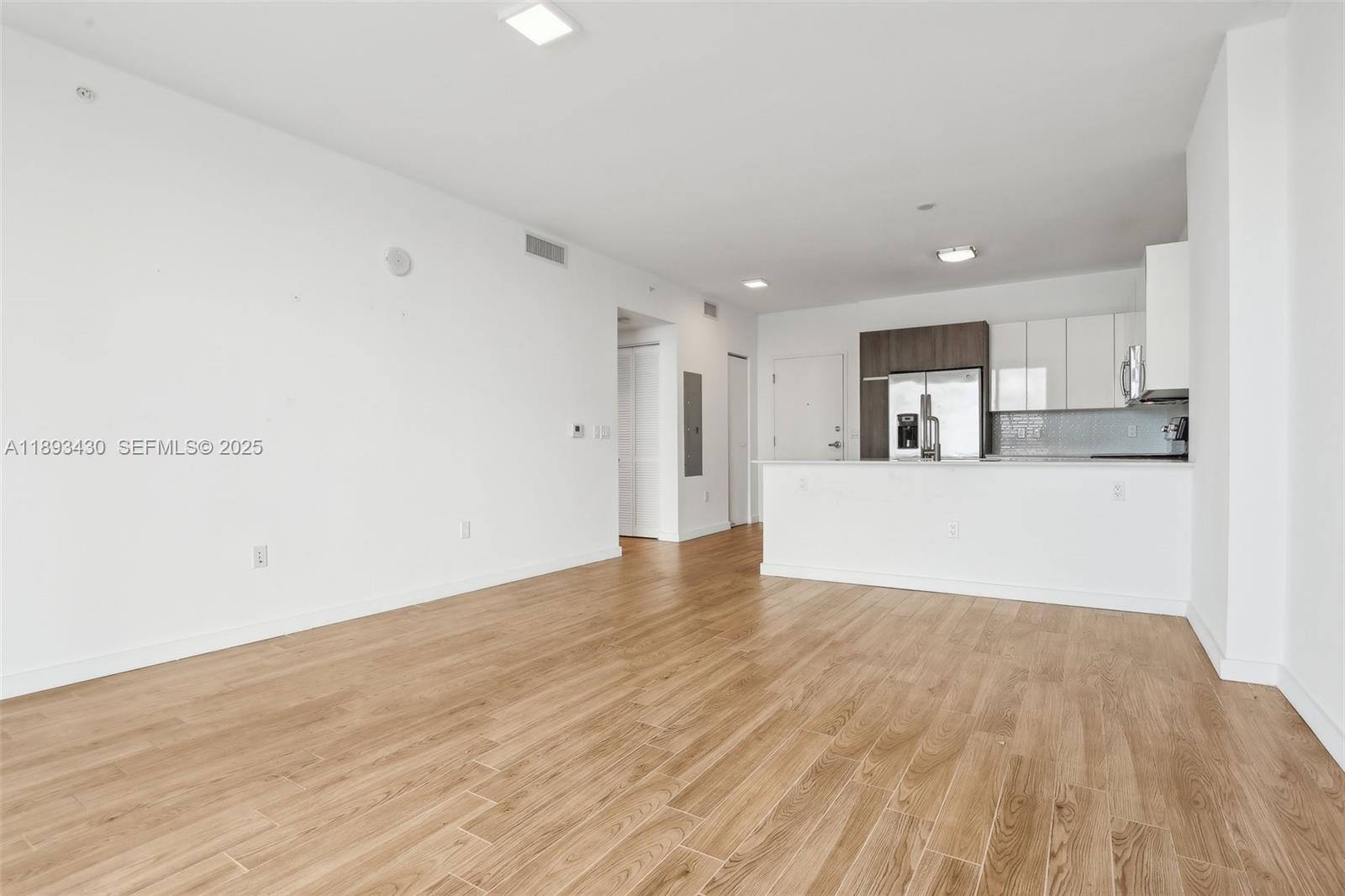 1501 Southwest 37th Avenue, Unit 708 Miami, FL 33145 - Photo 6 of 27 a view of a kitchen with wooden floor and electronic appliances