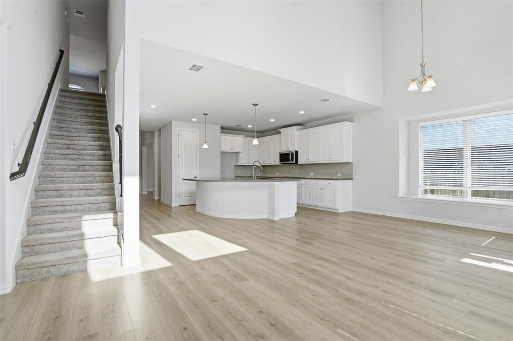 461 Windy Knoll Road Fort Worth, TX 76028 - Photo 11 of 30 a view of kitchen with cabinets and wooden floor