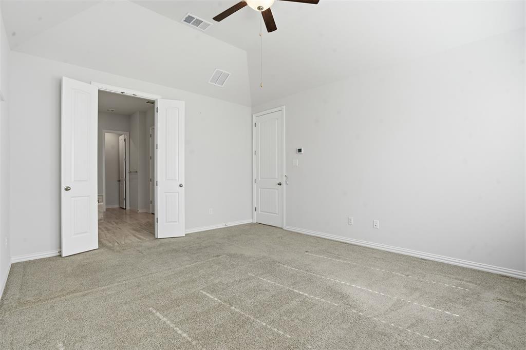 461 Windy Knoll Road Fort Worth, TX 76028 - Photo 14 of 30 an empty room with a ceiling fan and window