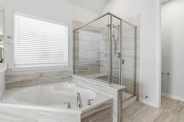 a bathroom with a bathtub and a shower