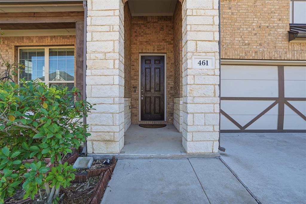 461 Windy Knoll Road Fort Worth, TX 76028 - Photo 2 of 30 front view of a brick house with a bench and potted plants