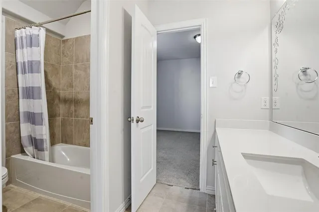 a bathroom with a tub and shower