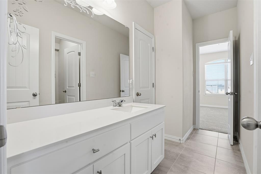 461 Windy Knoll Road Fort Worth, TX 76028 - Photo 23 of 30 a bathroom with a sink and a mirror