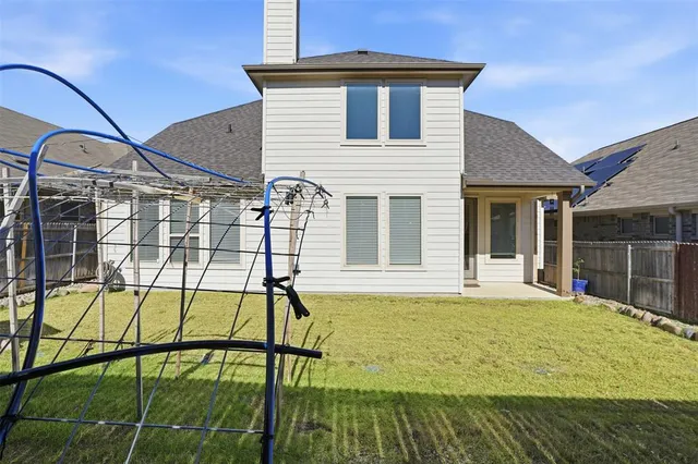 a view of a house with a backyard