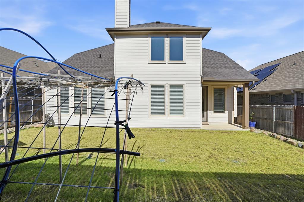 461 Windy Knoll Road Fort Worth, TX 76028 - Photo 26 of 30 a view of a house with a backyard