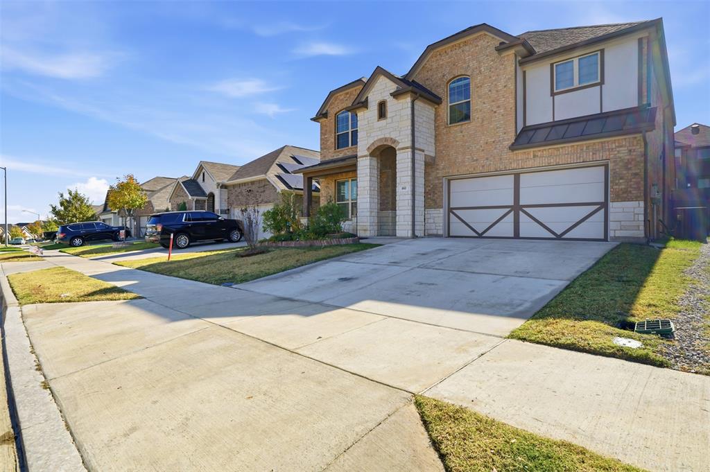 461 Windy Knoll Road Fort Worth, TX 76028 - Photo 28 of 30 a front view of a house with a garden and parking