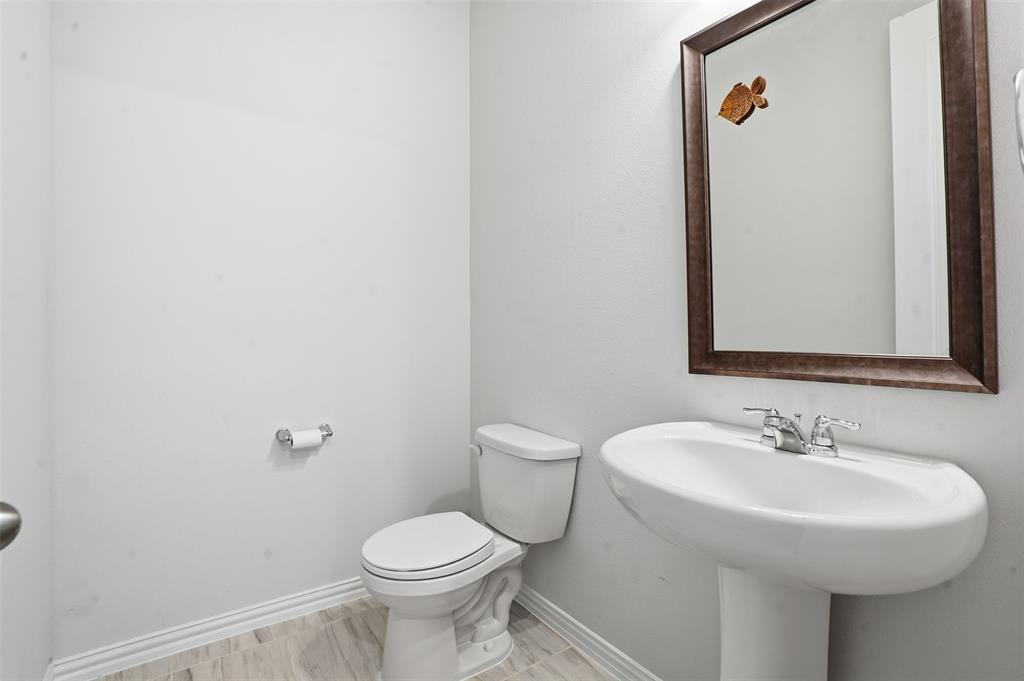 461 Windy Knoll Road Fort Worth, TX 76028 - Photo 5 of 30 a bathroom with a sink toilet and a mirror