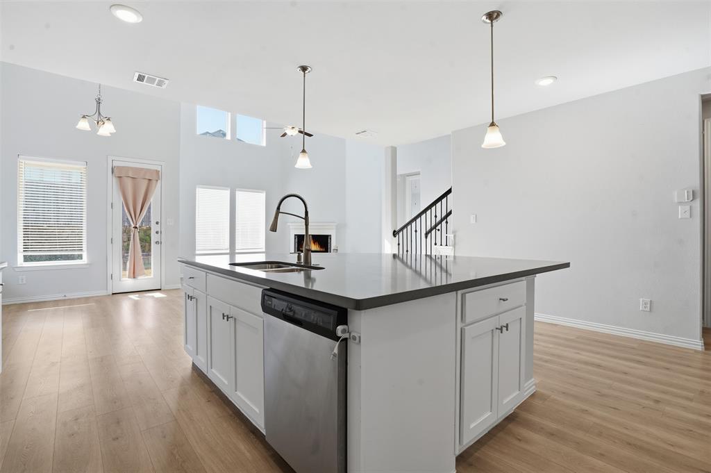 461 Windy Knoll Road Fort Worth, TX 76028 - Photo 9 of 30 a kitchen with sink microwave and stove