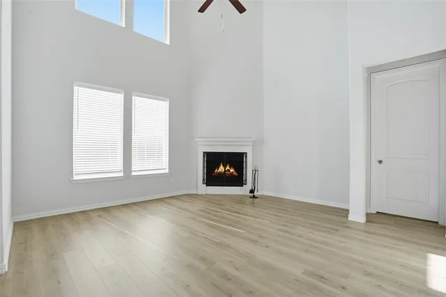 an empty room with wooden floor and a window
