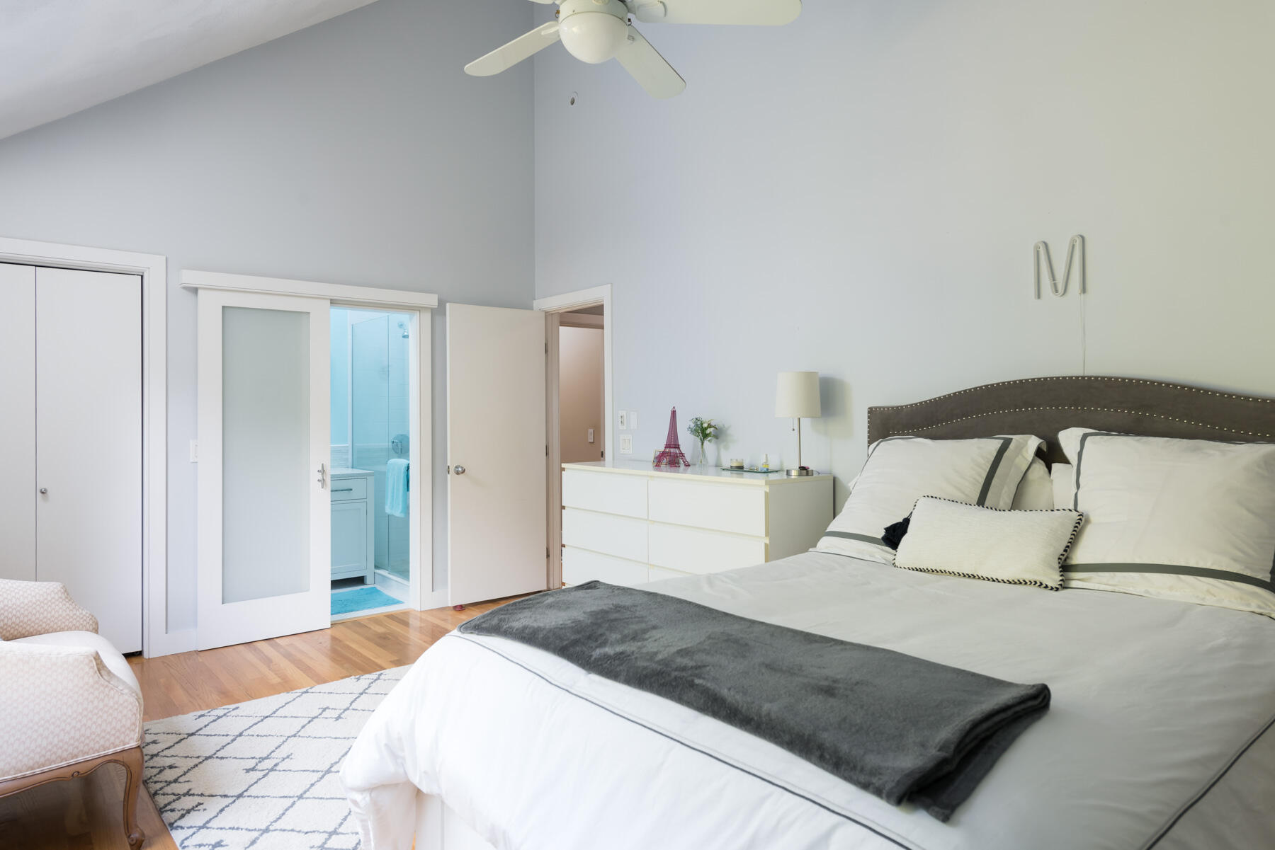 58 Delano Road Marion, MA 02738 - Photo 22 of 41 a bedroom with a large bed and a chandelier