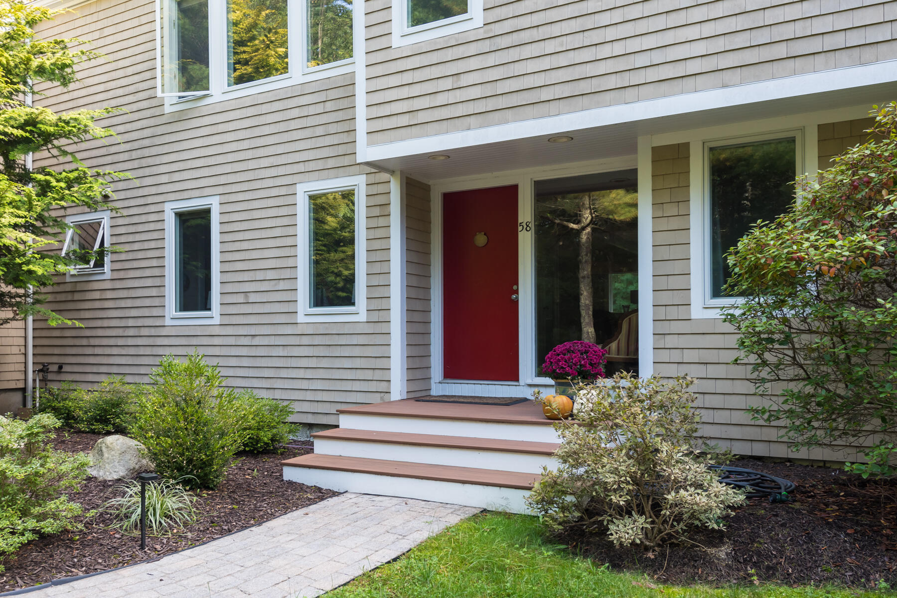 58 Delano Road Marion, MA 02738 - Photo 5 of 41 a front view of a house with plants