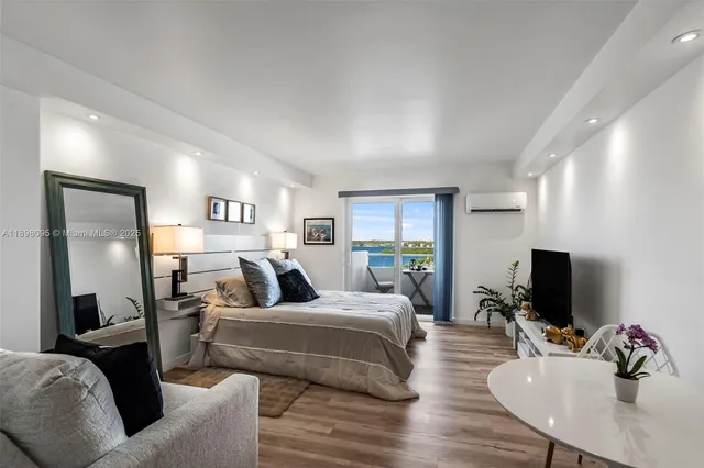 a bedroom with furniture and a flat screen tv