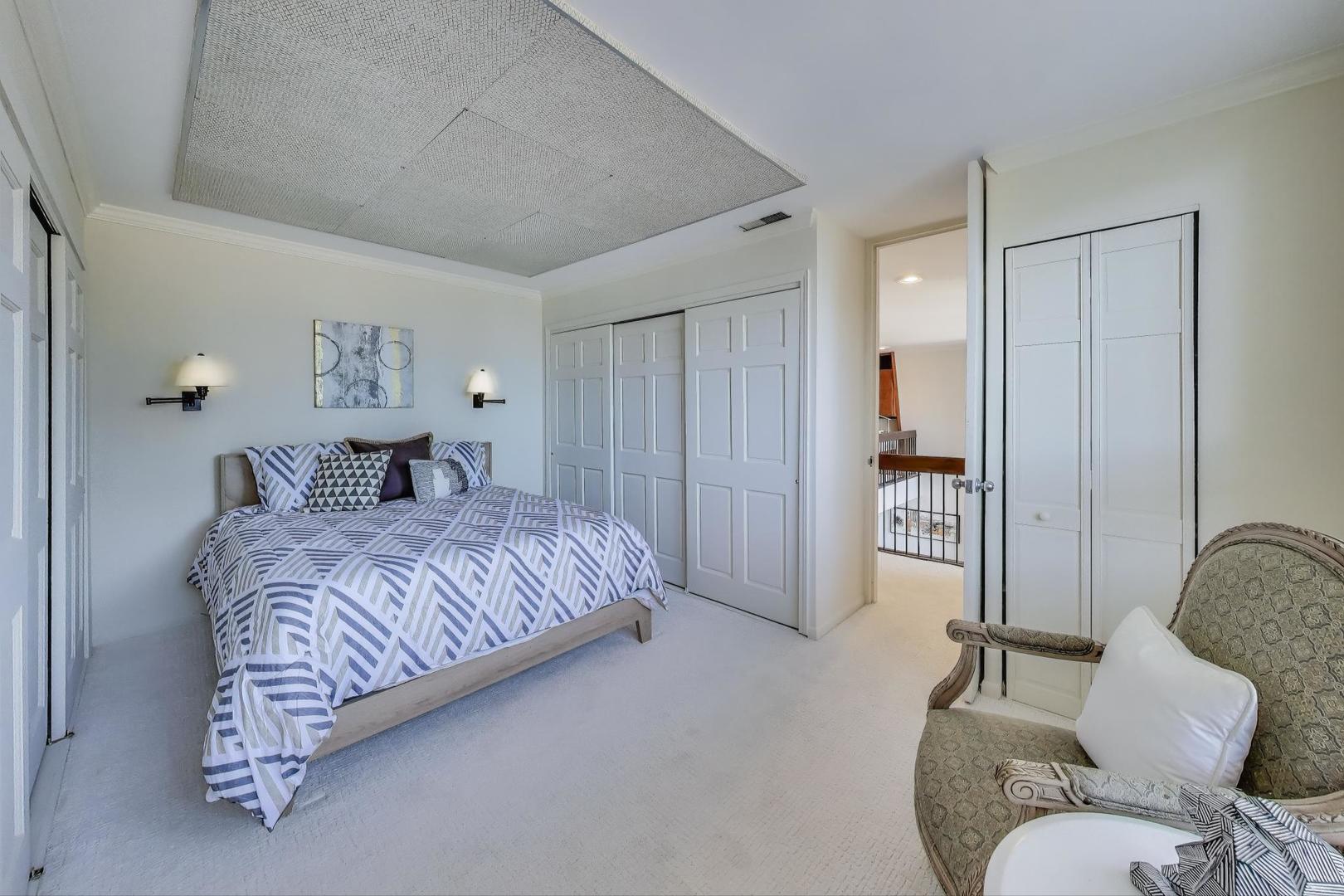 201 East Chestnut Street, Unit 24C Chicago, IL 60611 - Photo 24 of 33 a bedroom with a bed and a chair