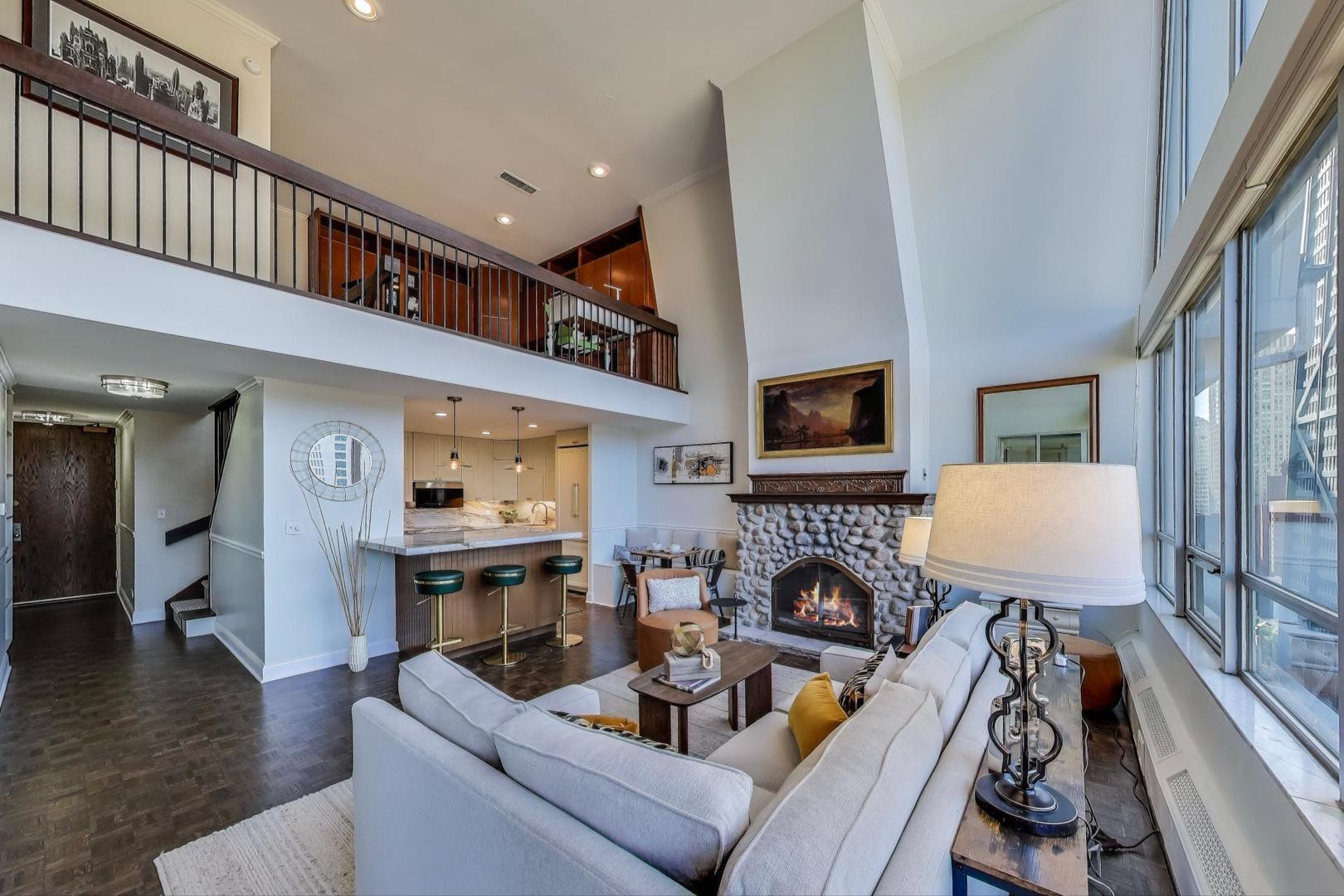 201 East Chestnut Street, Unit 24C Chicago, IL 60611 - Photo 6 of 33 a living room with fireplace furniture and a flat screen tv
