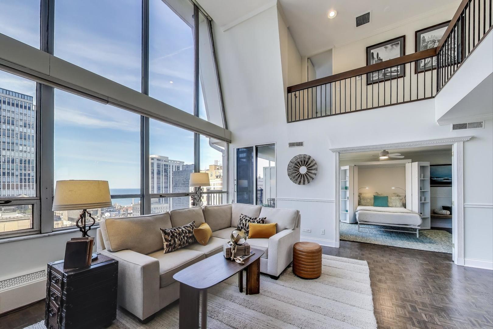 201 East Chestnut Street, Unit 24C Chicago, IL 60611 - Photo 10 of 33 a living room with furniture and wooden floor