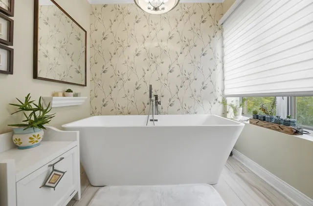 a bathroom with a bathtub a sink and a window