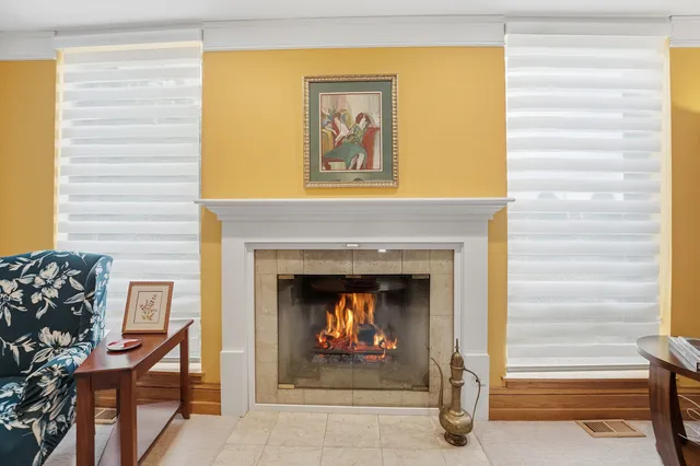 a living room with a fireplace and a window