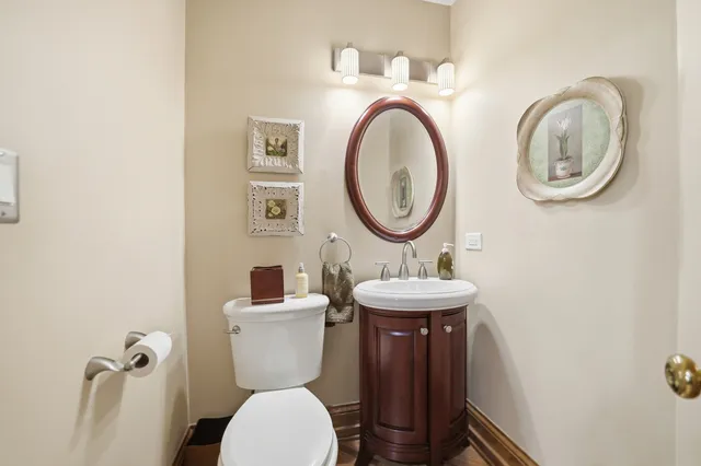 a bathroom with a toilet a sink and a mirror