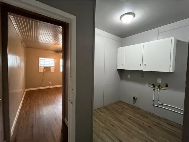 a view of hallway with wooden floor