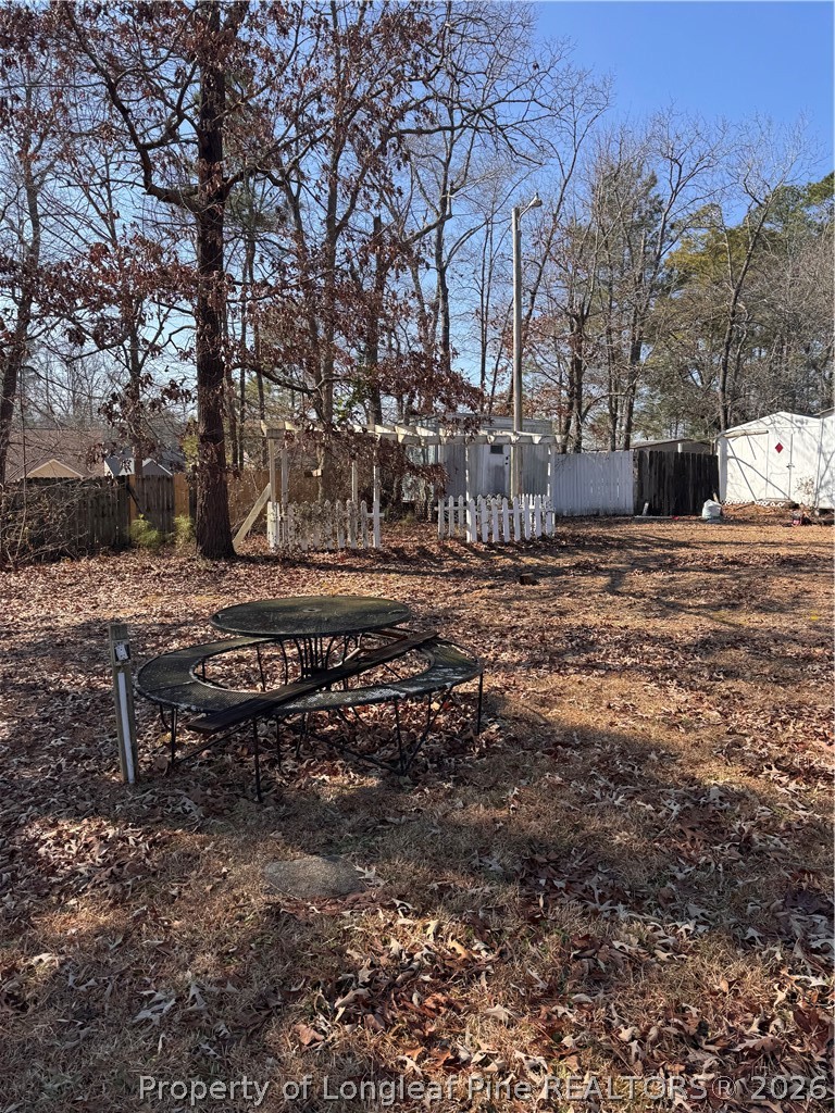 1188 Cypress Lakes Road Hope Mills, NC 28348 - Photo 3 of 9 a view of a yard with a bench