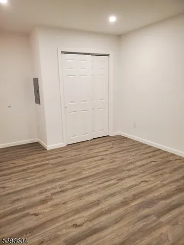 a view of a room with wooden floor and window