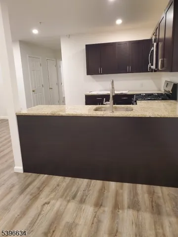 a kitchen with stainless steel appliances a sink and a refrigerator