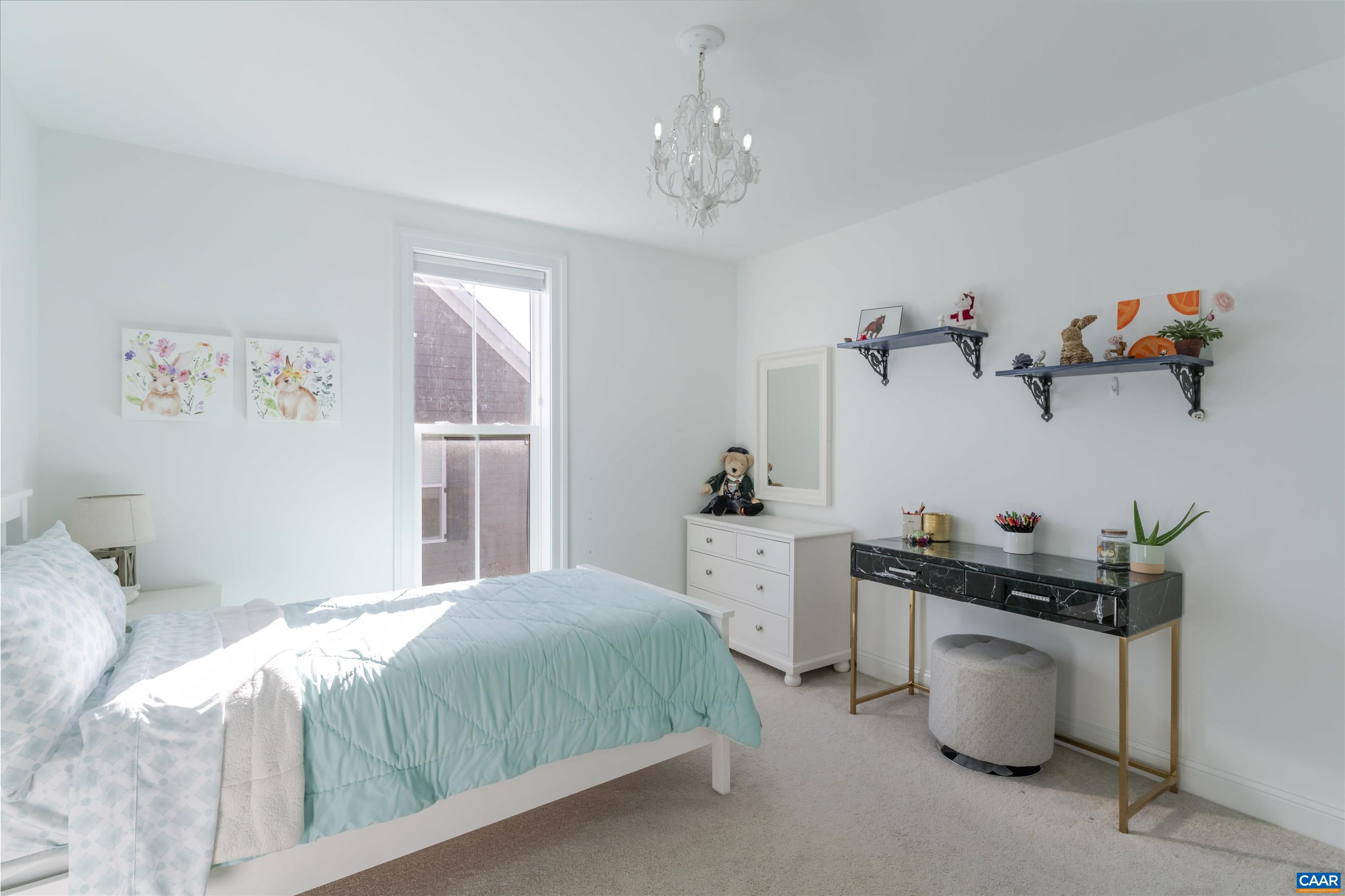 312 Bishopgate Lane Crozet, VA 22932 - Photo 17 of 22 a bedroom with a bed and a chandelier