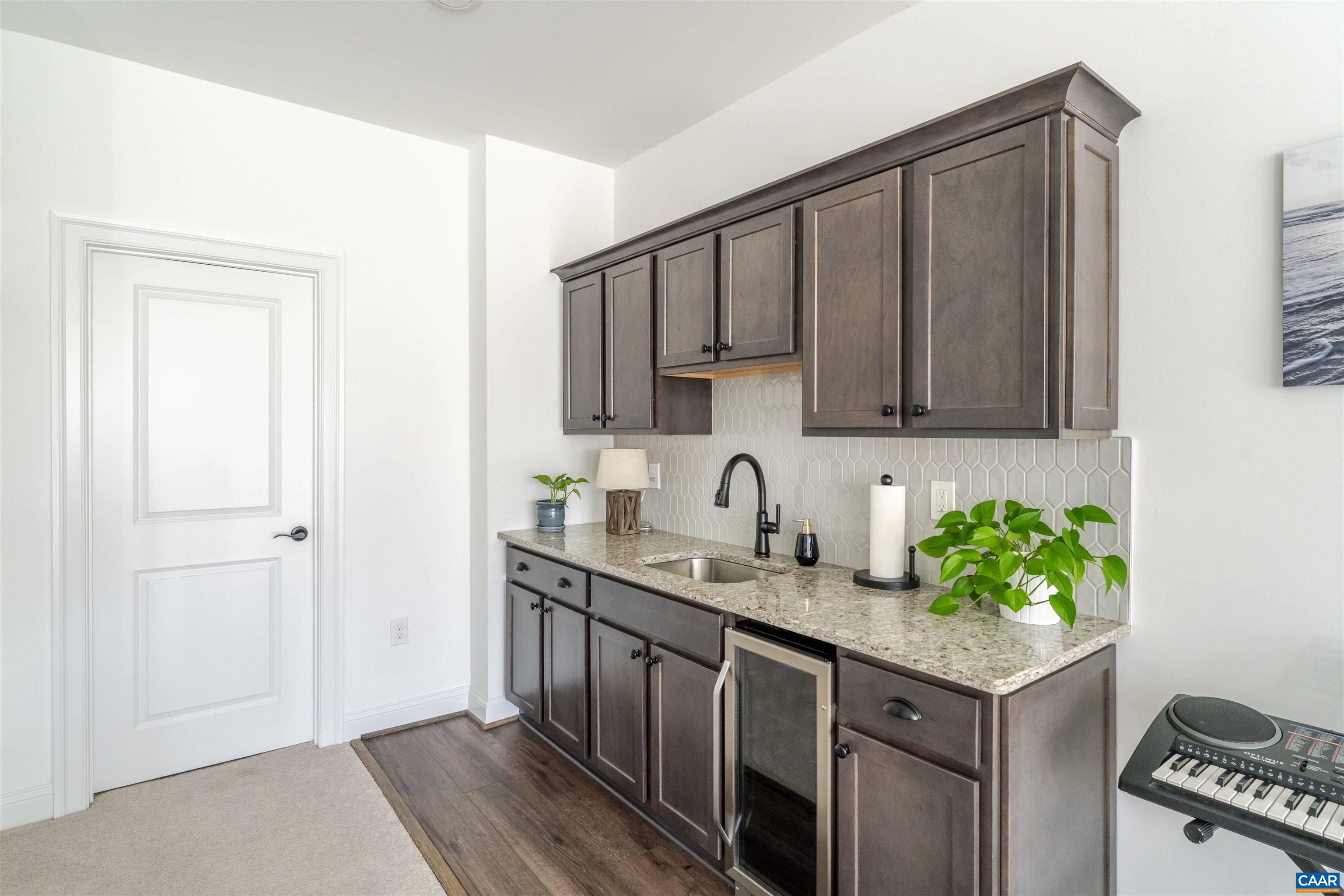 312 Bishopgate Lane Crozet, VA 22932 - Photo 18 of 22 a kitchen with stainless steel appliances granite countertop a sink stove and cabinets