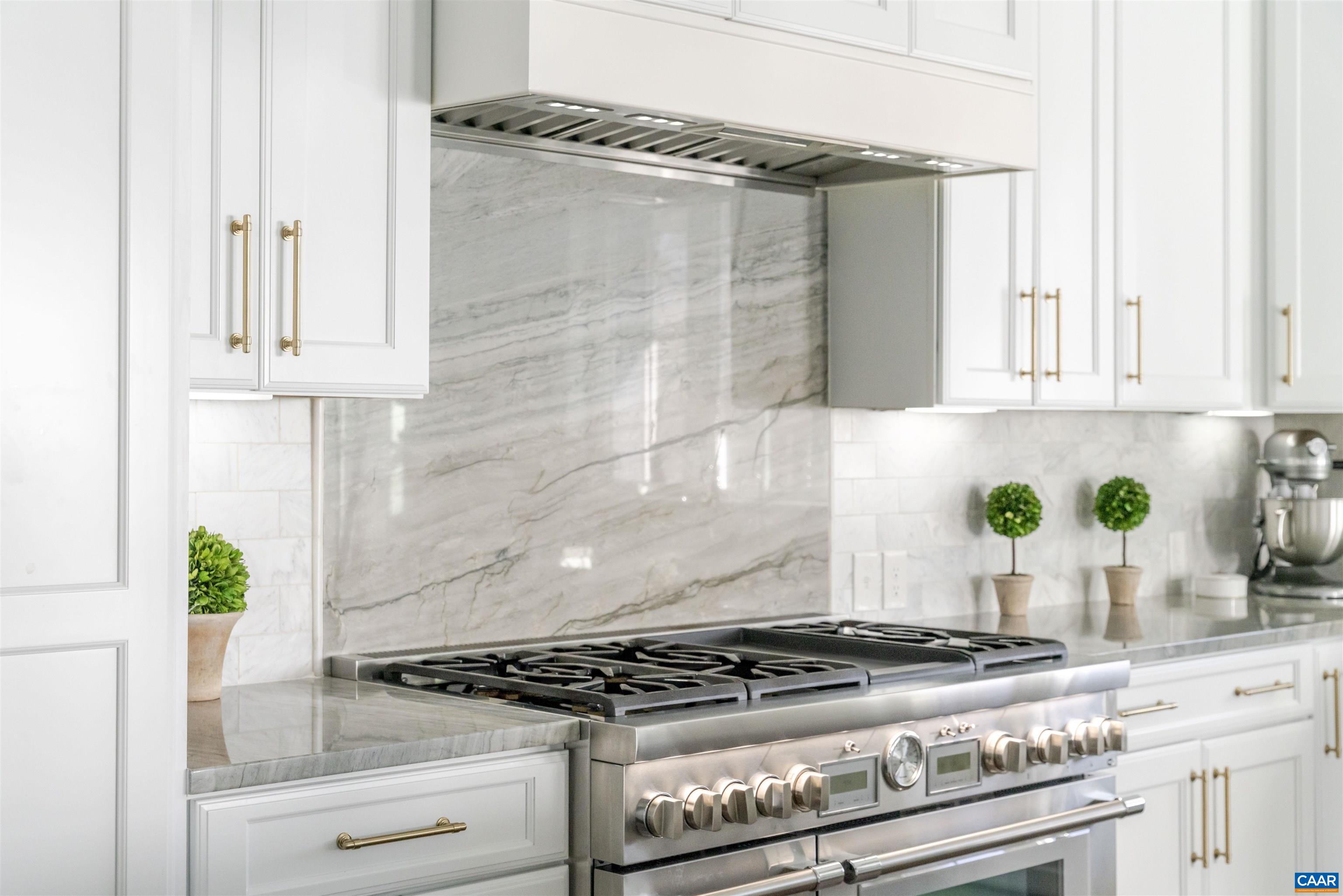 312 Bishopgate Lane Crozet, VA 22932 - Photo 7 of 22 a kitchen with granite countertop white cabinets and a stove