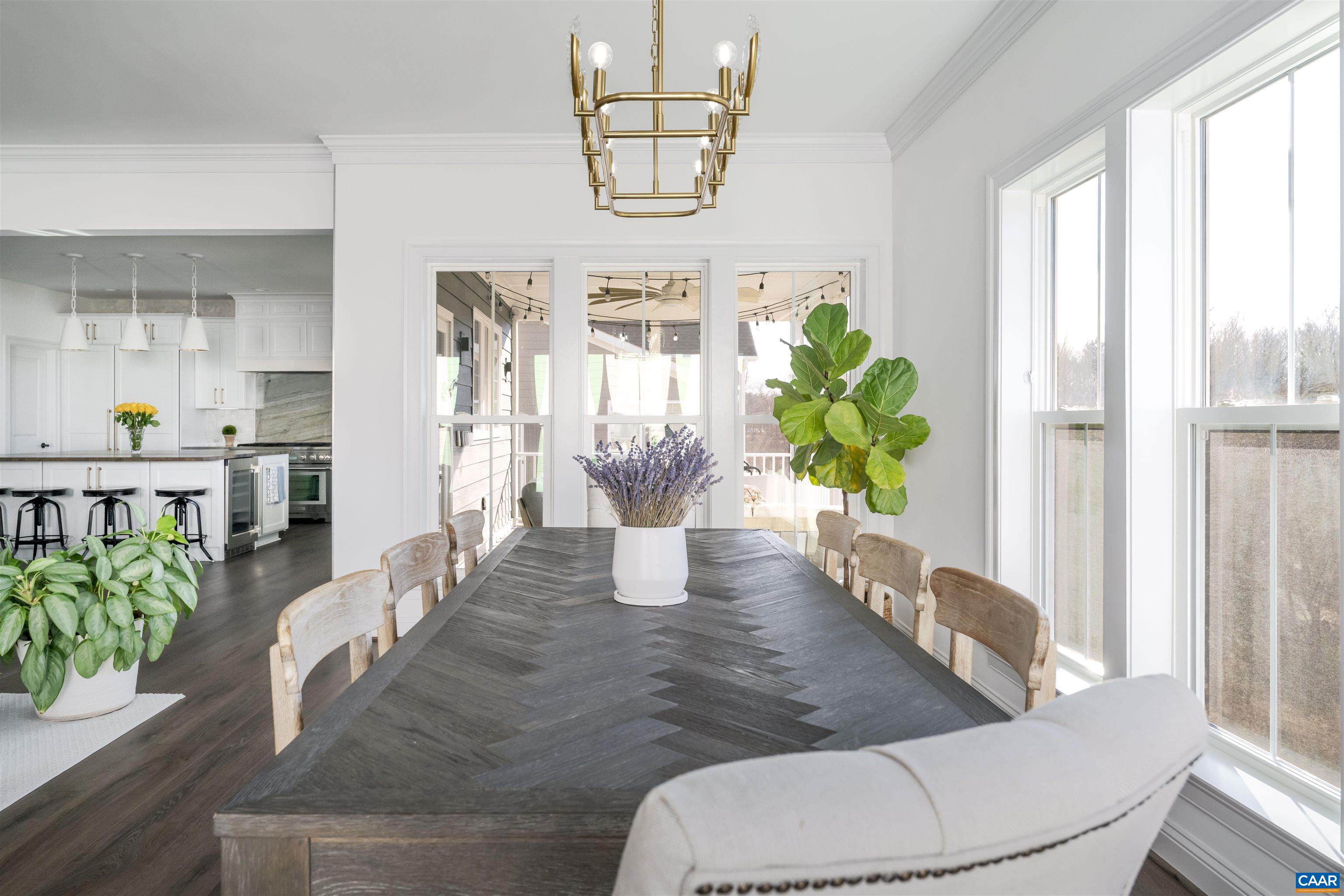 312 Bishopgate Lane Crozet, VA 22932 - Photo 9 of 22 a dining room with furniture a potted plant and wooden floor
