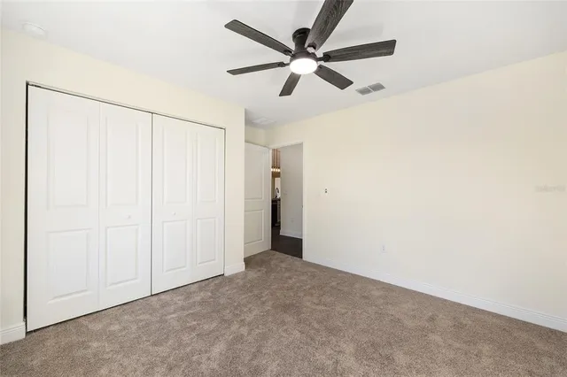 a bathroom with a granite countertop sink a toilet and a bathtub