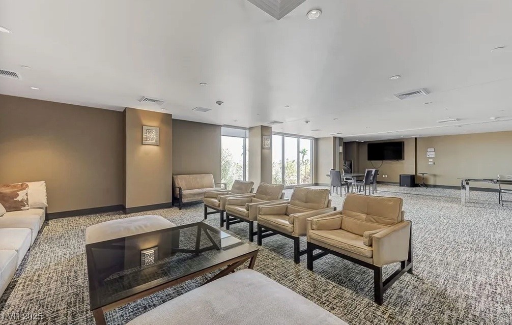 8255 South Las Vegas Boulevard, Unit 1504 Las Vegas, NV 89123 - Photo 21 of 29 Carpeted living area with visible vents and basebo