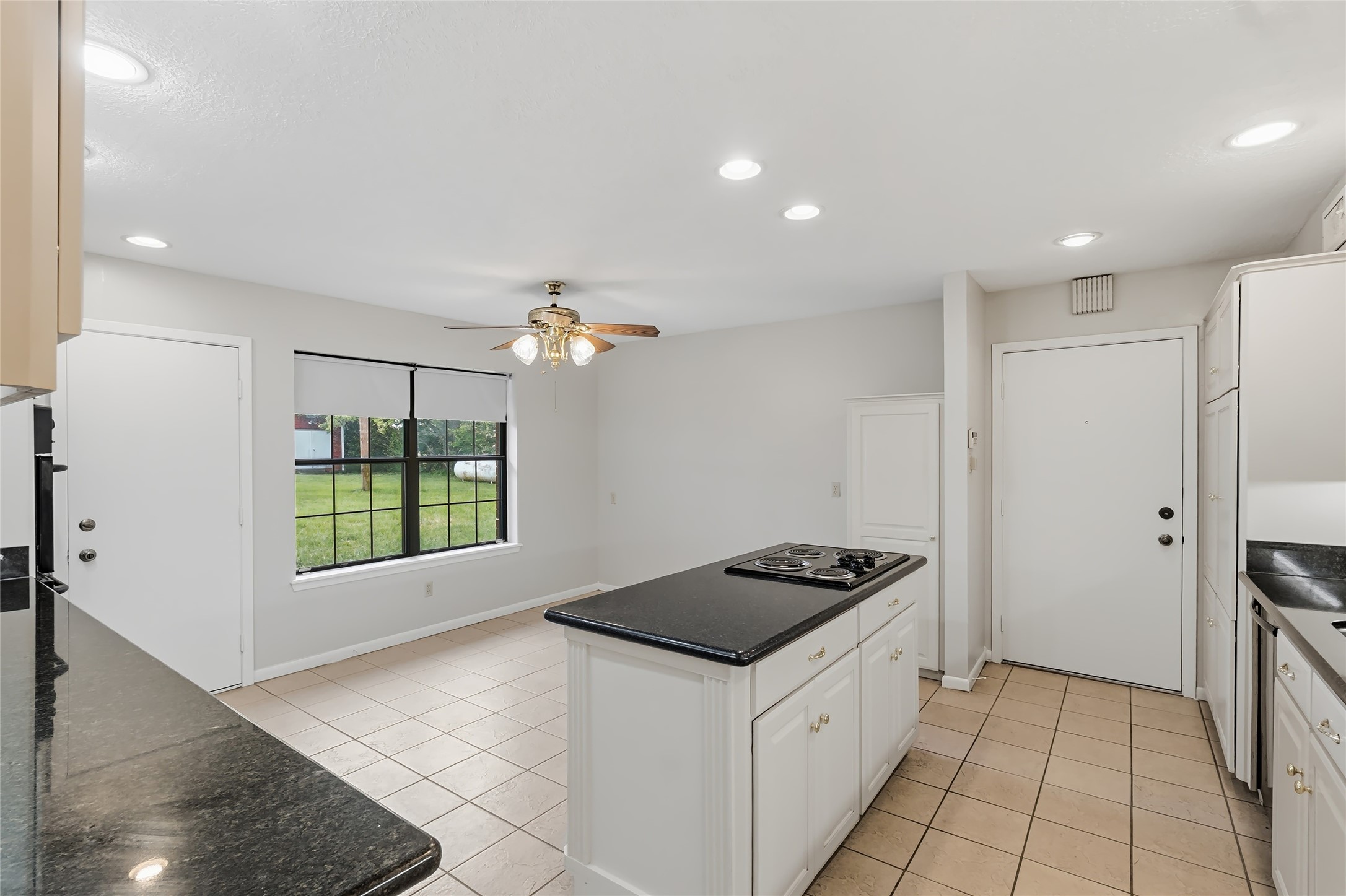 807 Standley Road Madisonville, TX 77864 - Photo 16 of 35 a kitchen with a stove a refrigerator and a cabinets with wooden floor