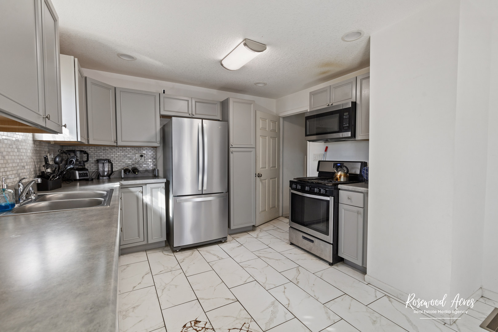 245 North 6th Avenue Kankakee, IL 60901 - Photo 6 of 16 a kitchen with a sink a stove and refrigerator