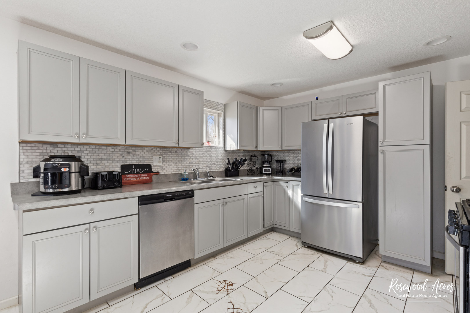 245 North 6th Avenue Kankakee, IL 60901 - Photo 7 of 16 a kitchen with a refrigerator sink and cabinets