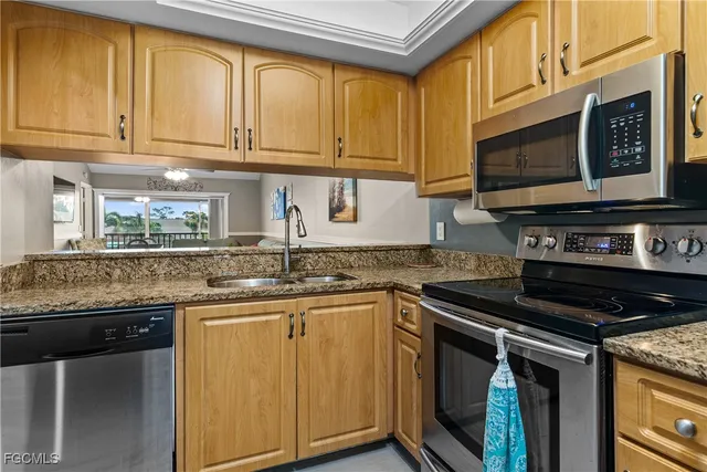 a kitchen with stainless steel appliances granite countertop a stove and a microwave