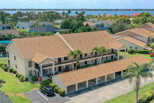 an aerial view of a house with a yard balcony and outdoor seating