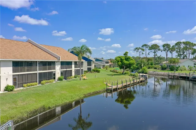 a view of a house with pool and a yard