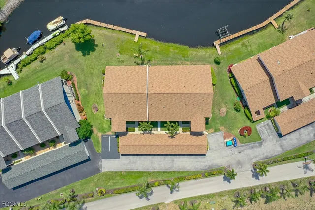 an aerial view of a house with a garden and outdoor seating