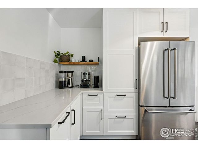 a kitchen with stainless steel appliances a refrigerator and cabinets