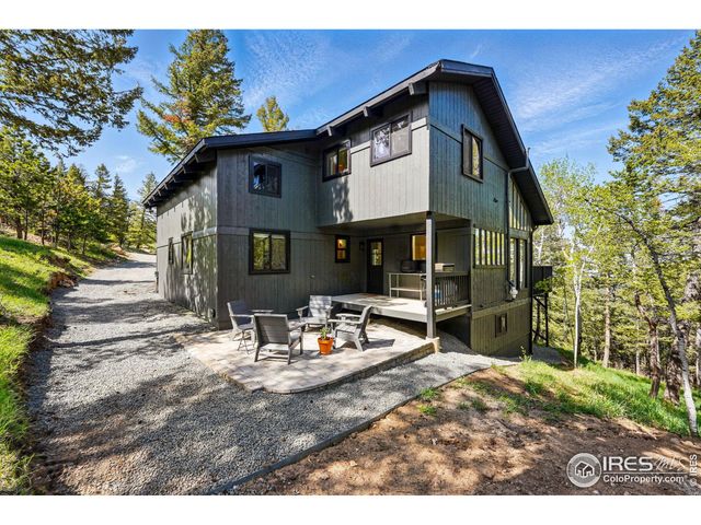 a view of house with backyard outdoor seating and green space