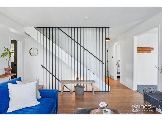 a view of a living room and a window with furniture