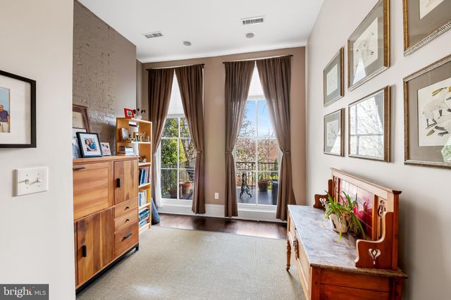 a living room with furniture cabinets and a book shelf