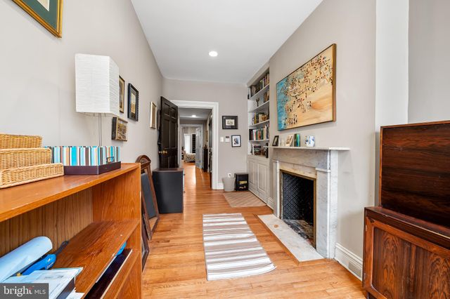 a bedroom with a bed and a fireplace